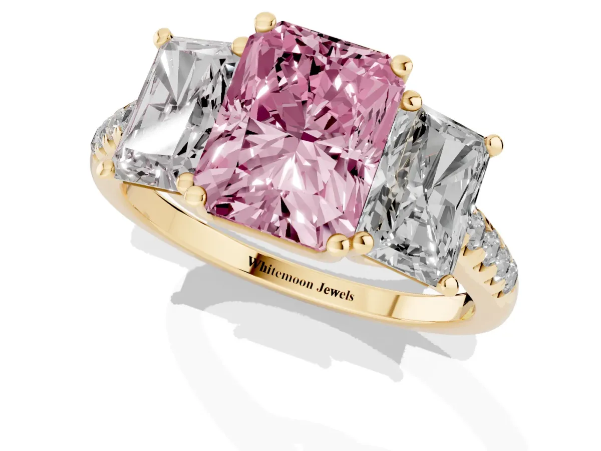 Fancy Pink Three-Stone Radiant Cut Diamond Ring with Round Pavé Band and Prong Setting Yellow gold