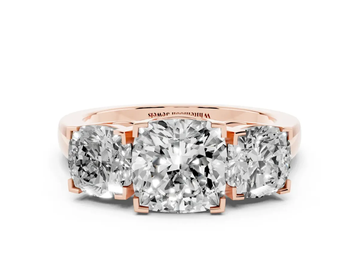 Three-Stone Cushion Cut Cut Diamond Ring with Channel Set Band and Four-Prong Setting Rose gold