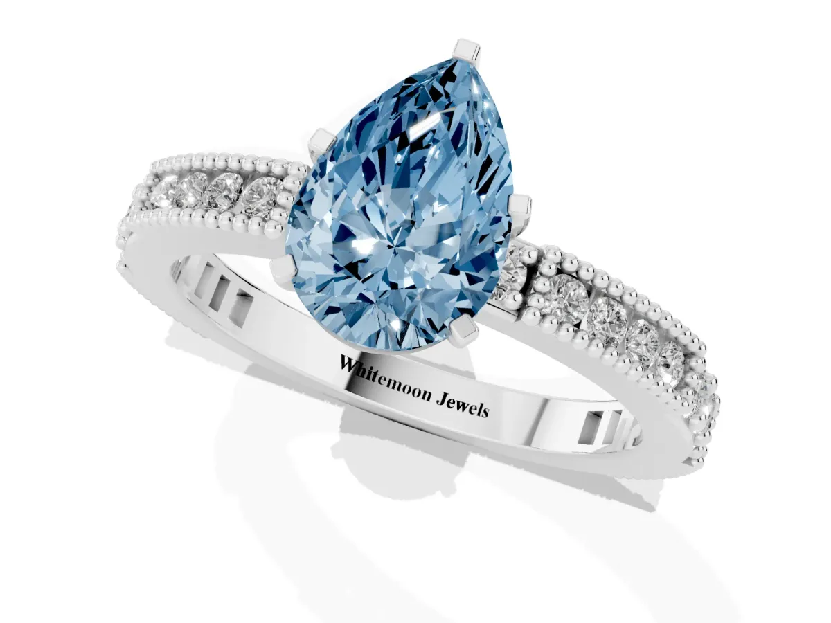 Fancy Blue Pear Cut Solitaire with Pavé Band and Four-Prong Setting Platinum