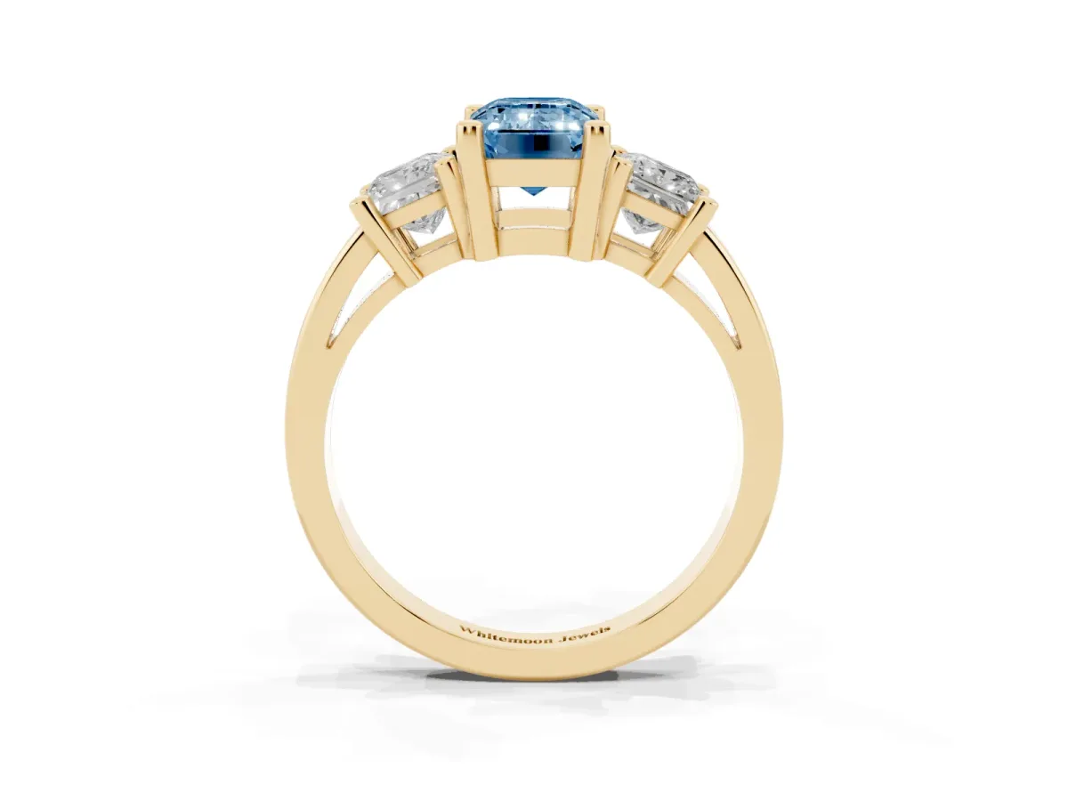 Fancy Blue Three-Stone Emerald Cut Cut Solitaire Ring with Prong Setting Yellow gold