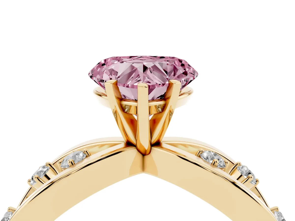 Fancy Pink Heart Cut Cut Solitaire Diamond with Side Stones on Criss-Cross Band and Four-Prong Setting Yellow gold