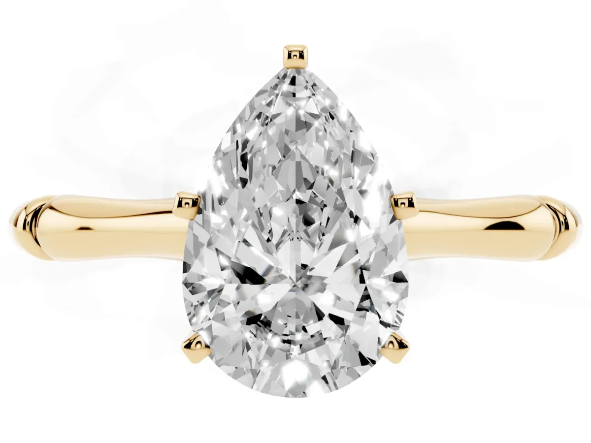 Pear Cut Solitaire Diamond Ring with Bamboo Band and Four-Prong Setting Yellow gold
