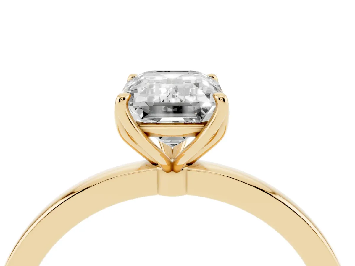 Emerald Cut Diamond Solitaire Ring with Thin Band and Prong Setting Yellow gold