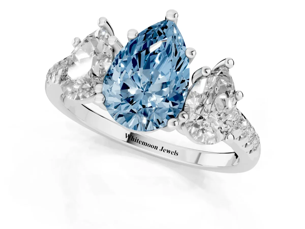 Fancy Blue Three-Stone Pear Cut Diamond Ring with Round Pavé Band and Prong Setting Silver
