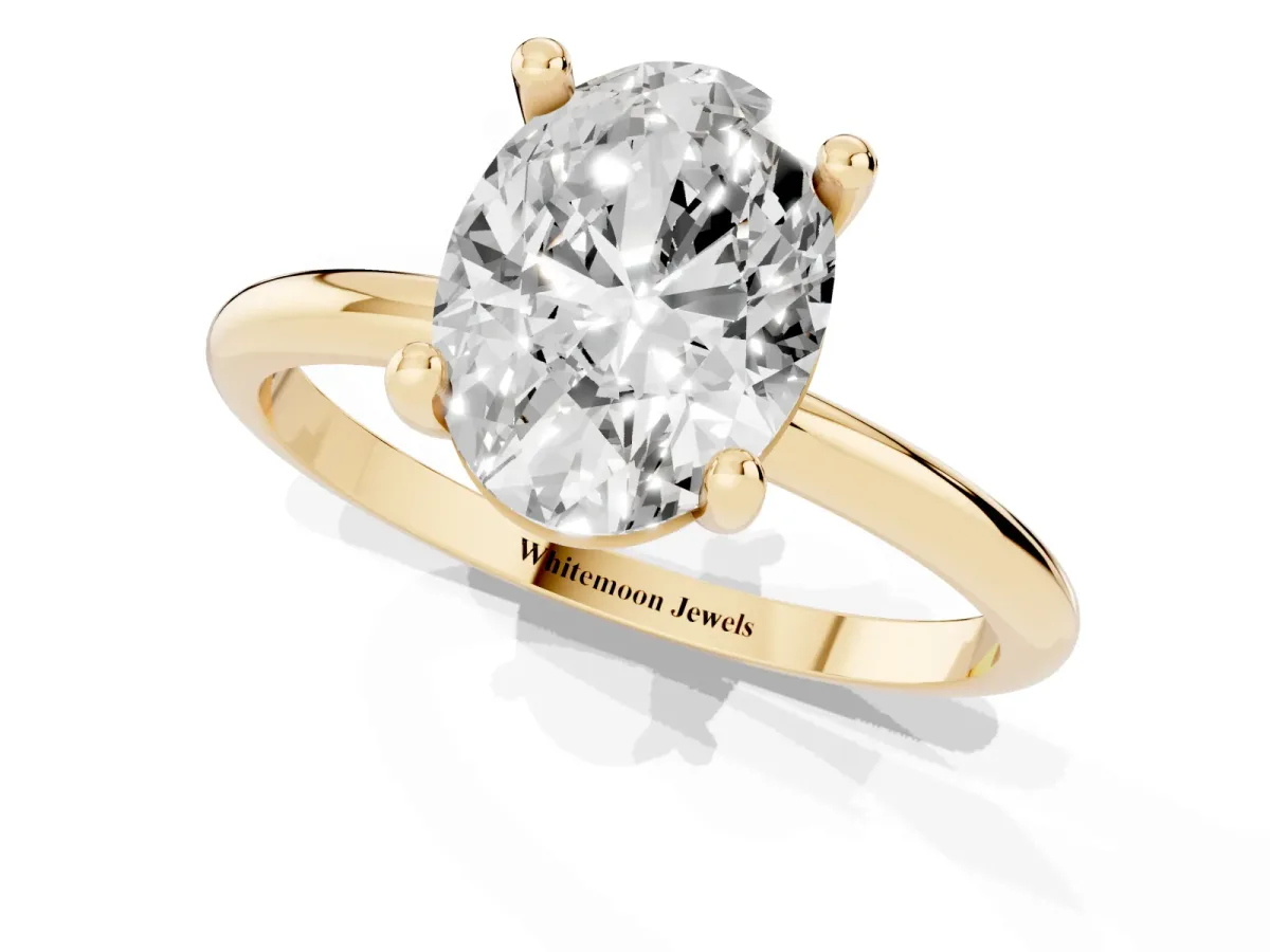 Oval Cut Solitaire Diamond Ring with 4-Prong Setting on a Classic Band Yellow gold