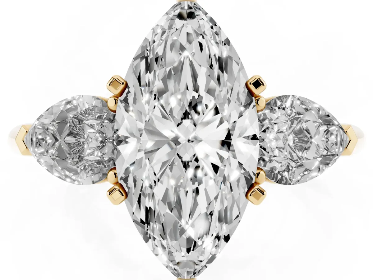Three-Stone Marquise Cut Diamond Ring with Pear Side Stones and Four-Prong Setting Yellow gold