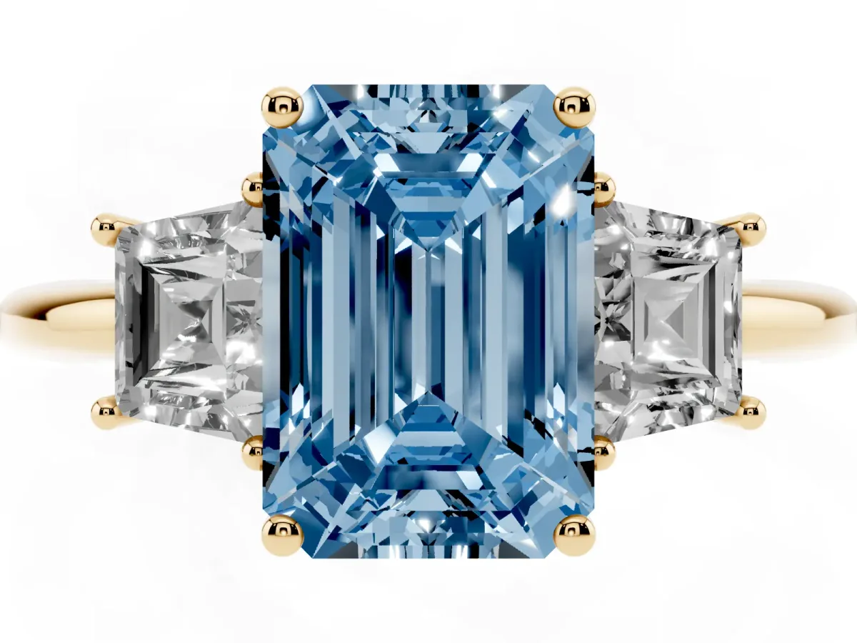 Fancy Blue Emerald Cut Diamond Three-Stone Ring with Trapezoid Side Stones and Prong Setting Yellow gold