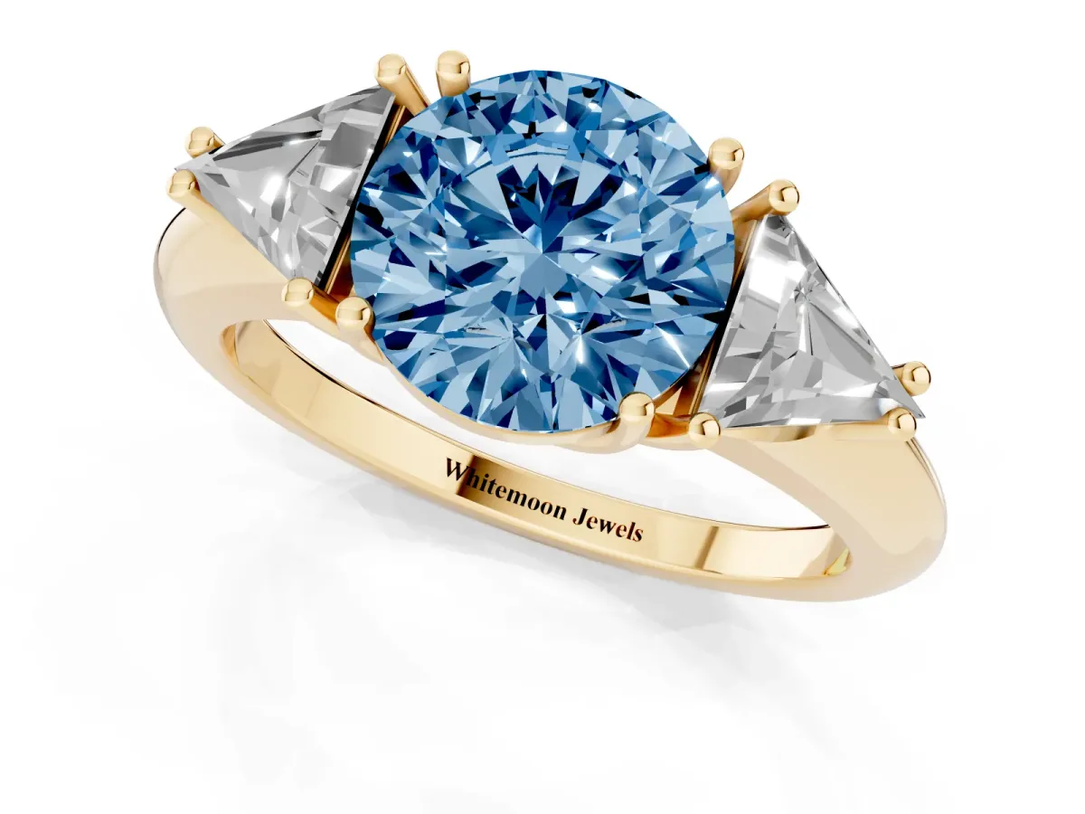 Fancy Blue Three-Stone Round Cut Diamond Engagement Ring with Trillion Side Stones and Prong Setting Yellow gold