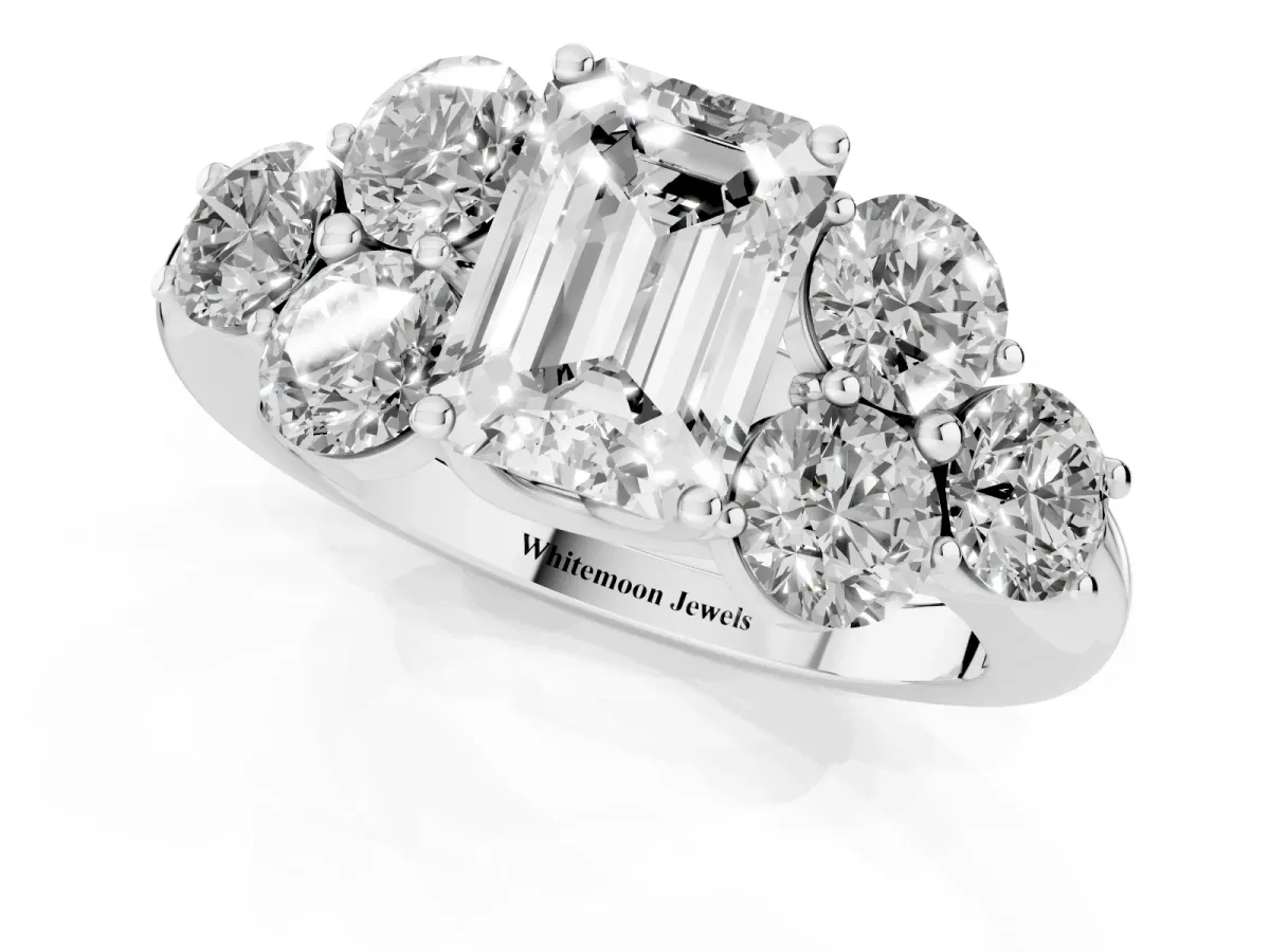 Emerald Cut Cut Diamond Cluster Ring with Round Accent Stones and Prong Setting on a Classic Band Silver