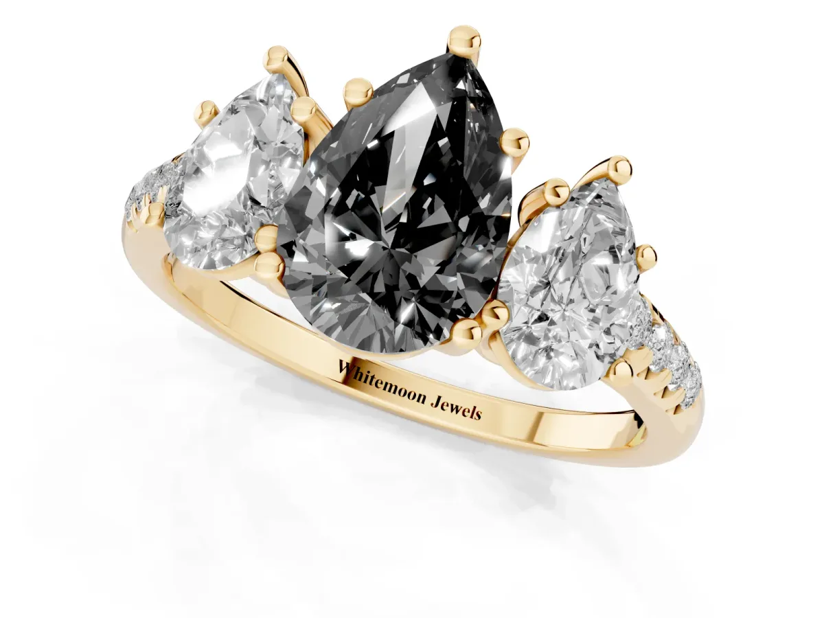 Fancy Black Three-Stone Pear Cut Diamond Ring with Round Pavé Band and Prong Setting Yellow gold