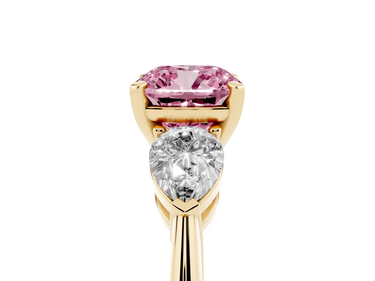 Fancy Pink Three-Stone Cushion Cut Diamond Ring with Pear Side Stones and Four-Prong Setting Yellow gold