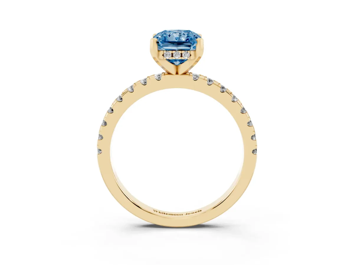 Fancy Blue Radiant Cut Diamond Solitaire Ring with Round Pavé Band and Four-Prong Setting Yellow gold