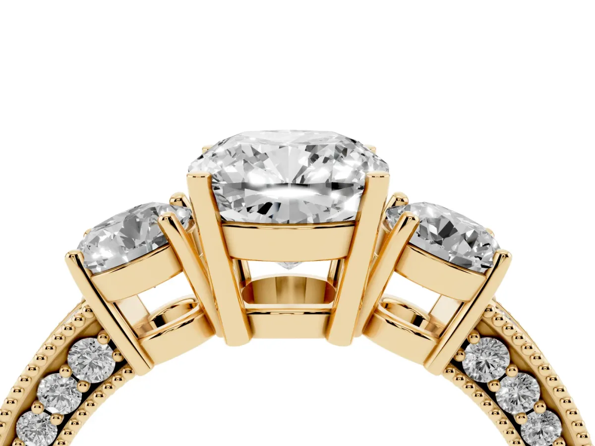 Cushion Cut Three-Stone Diamond Ring with Pavé Band and Four-Prong Setting Yellow gold