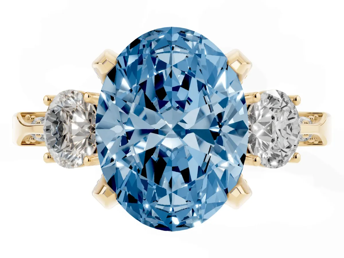 Fancy Blue Oval Cut Brilliant Three-Stone Diamond Ring with Pavé Band and Four-Prong Setting Yellow gold