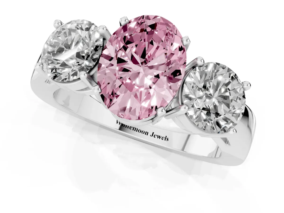 Fancy Pink Three-Stone Oval Cut Diamond Ring with Round Side Stones, Classic Band, and Four-Prong Setting Silver
