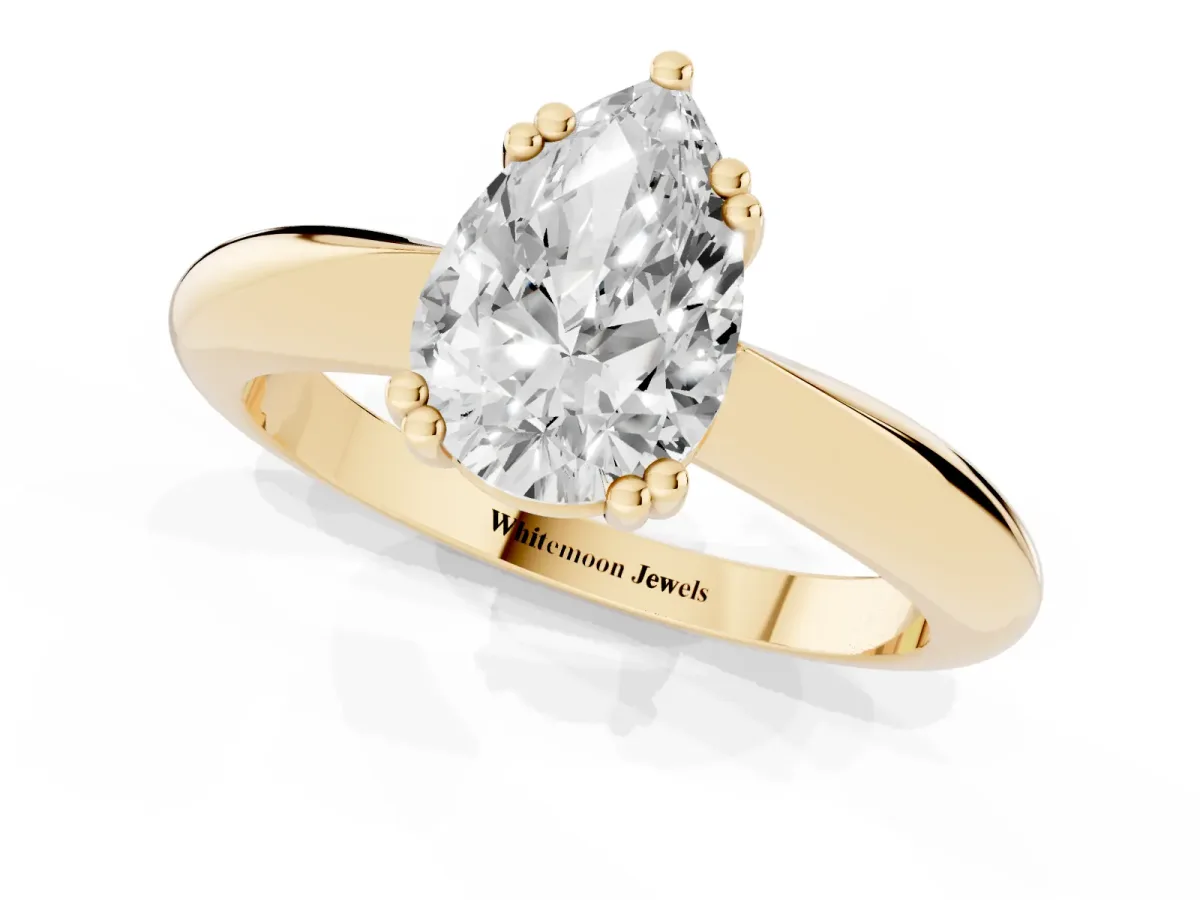 Pear Cut Cut Solitaire Engagement Ring with Tapered Band and Four-Prong Setting Yellow gold