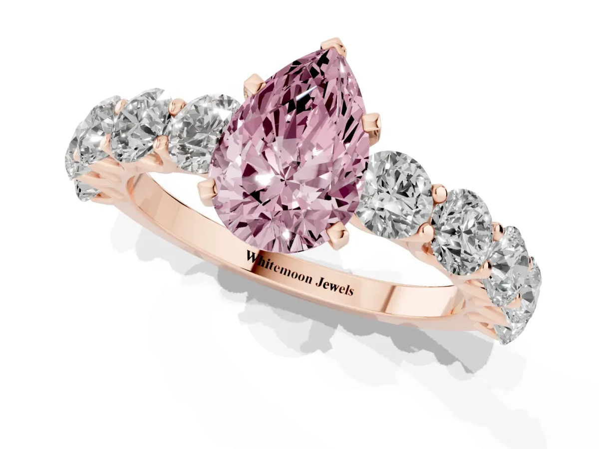 Fancy Pink Pear Cut Diamond Prong Setting with Side Stones on a Pave Band Rose gold