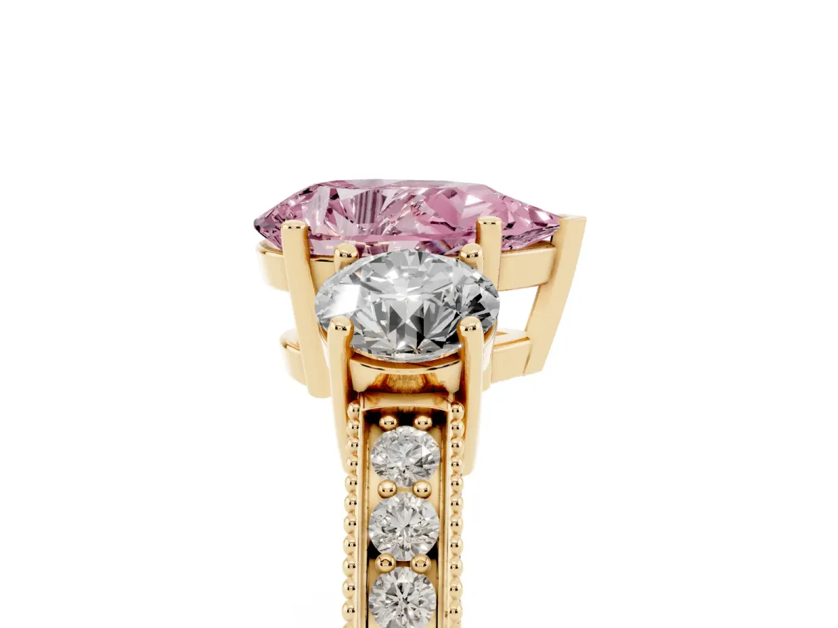 Fancy Pink Pear Cut Three-Stone Diamond Ring with Pavé Band and Four-Prong Setting Yellow gold