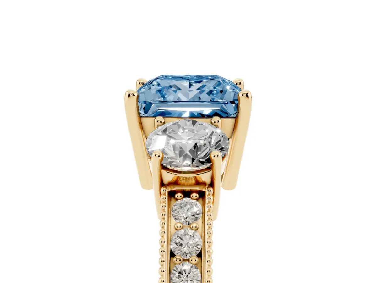 Fancy Blue Princess Cut Three-Stone Diamond Ring with Pavé Band and Four-Prong Setting Yellow gold