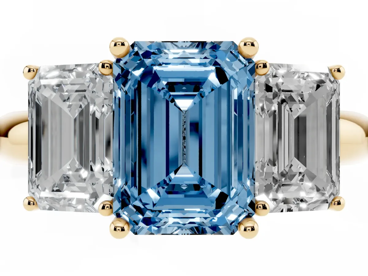 Fancy Blue Three-Stone Emerald Cut Cut Diamond Engagement Ring with Prong Setting on a White Gold Band Yellow gold