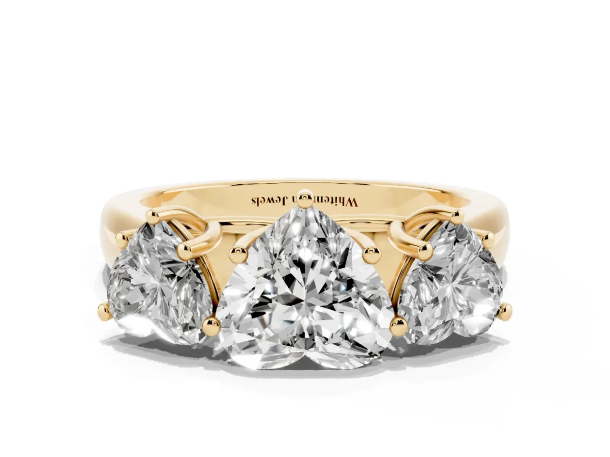 Heart Cut Three-Stone Diamond Ring with Prong Setting on a Classic Band Yellow gold