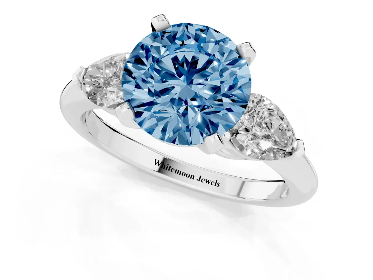 Fancy Blue Three-Stone Round Cut Diamond Ring with Pear Side Stones and Four-Prong Setting Platinum