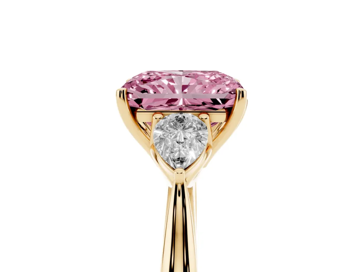 Fancy Pink Three-Stone Radiant Cut Diamond Ring with Pear Side Stones in Four-Prong Setting Yellow gold
