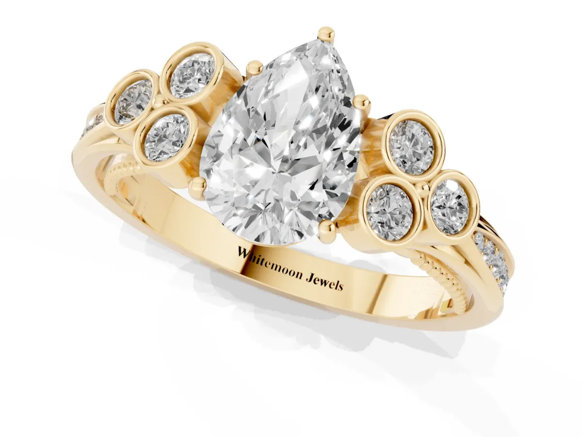 Pear Cut Cut Diamond Engagement Ring with Bezel Set Round Side Stones and Prong Setting Yellow gold
