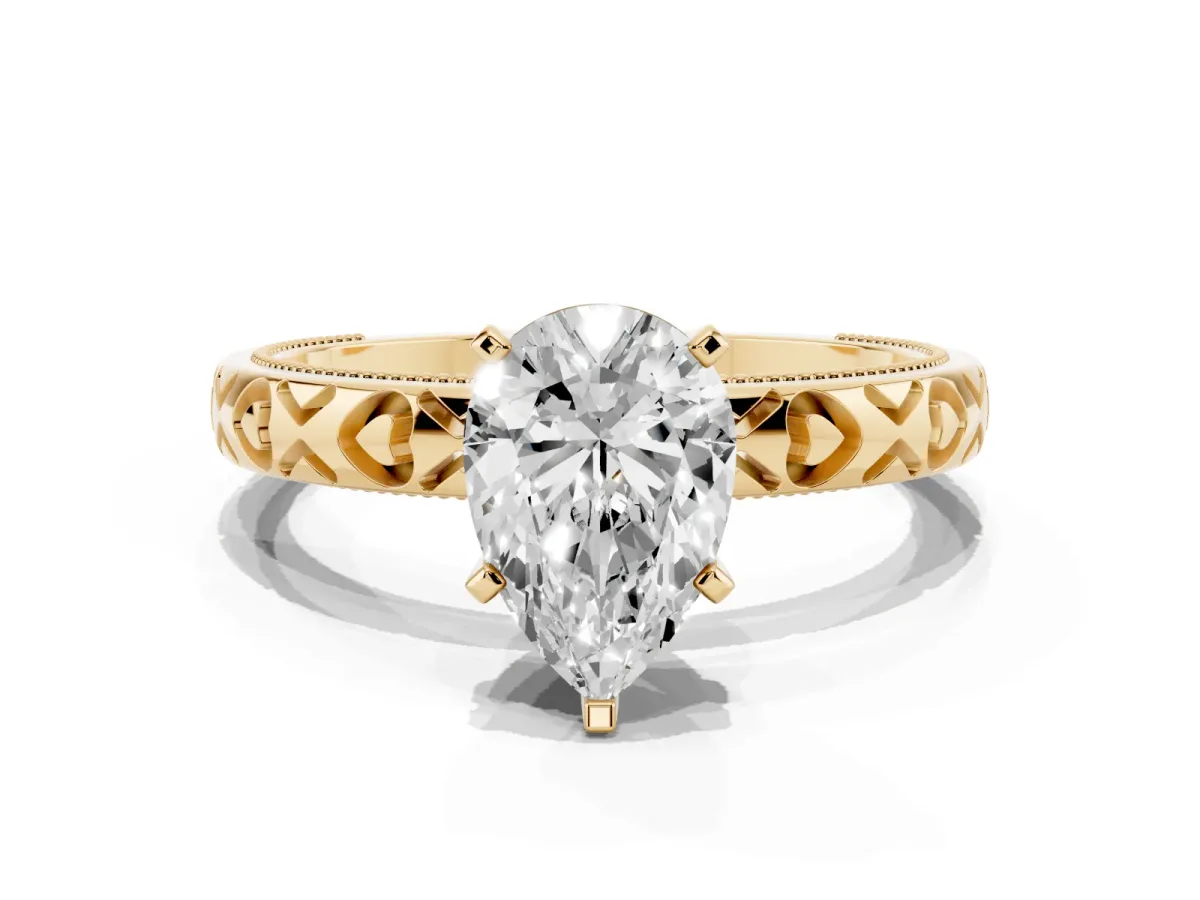 Pear Cut Solitaire Diamond Engagement Ring with XO Engraved Band and Four-Prong Setting Yellow gold