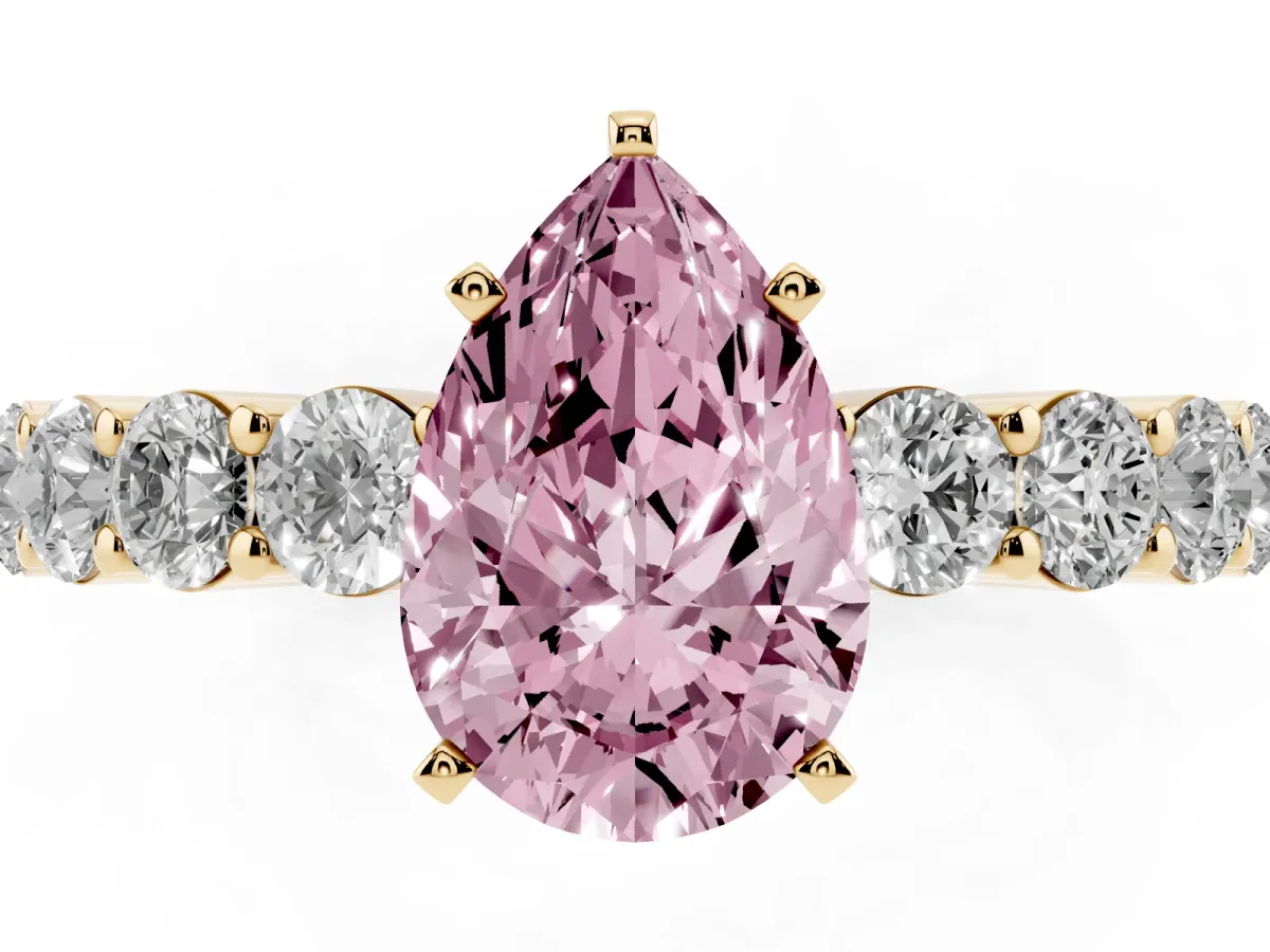 Fancy Pink Pear Cut Diamond Solitaire Ring with Shared Prong Round Side Stones Yellow gold