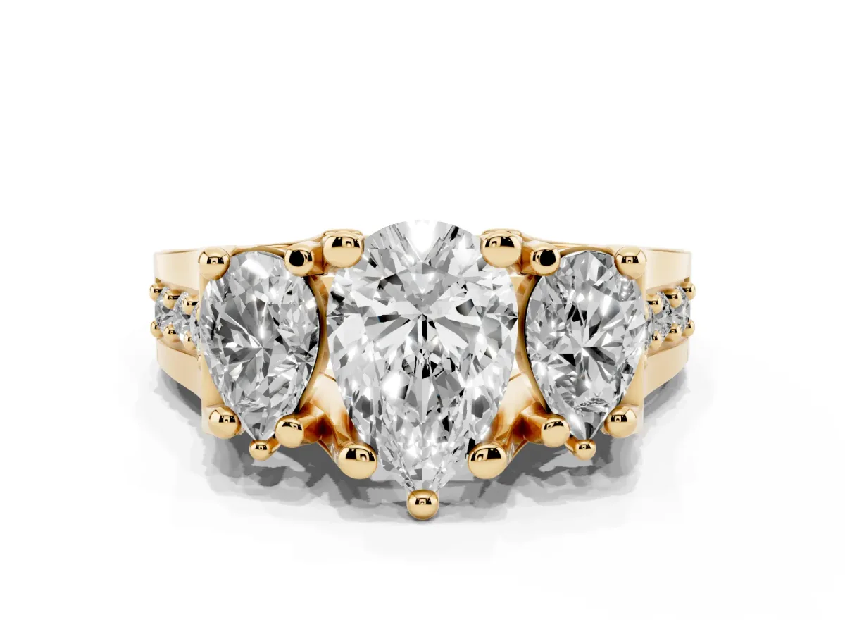 Pear Cut Diamond Three-Stone Ring with Channel Set Band and Four-Prong Setting Yellow gold