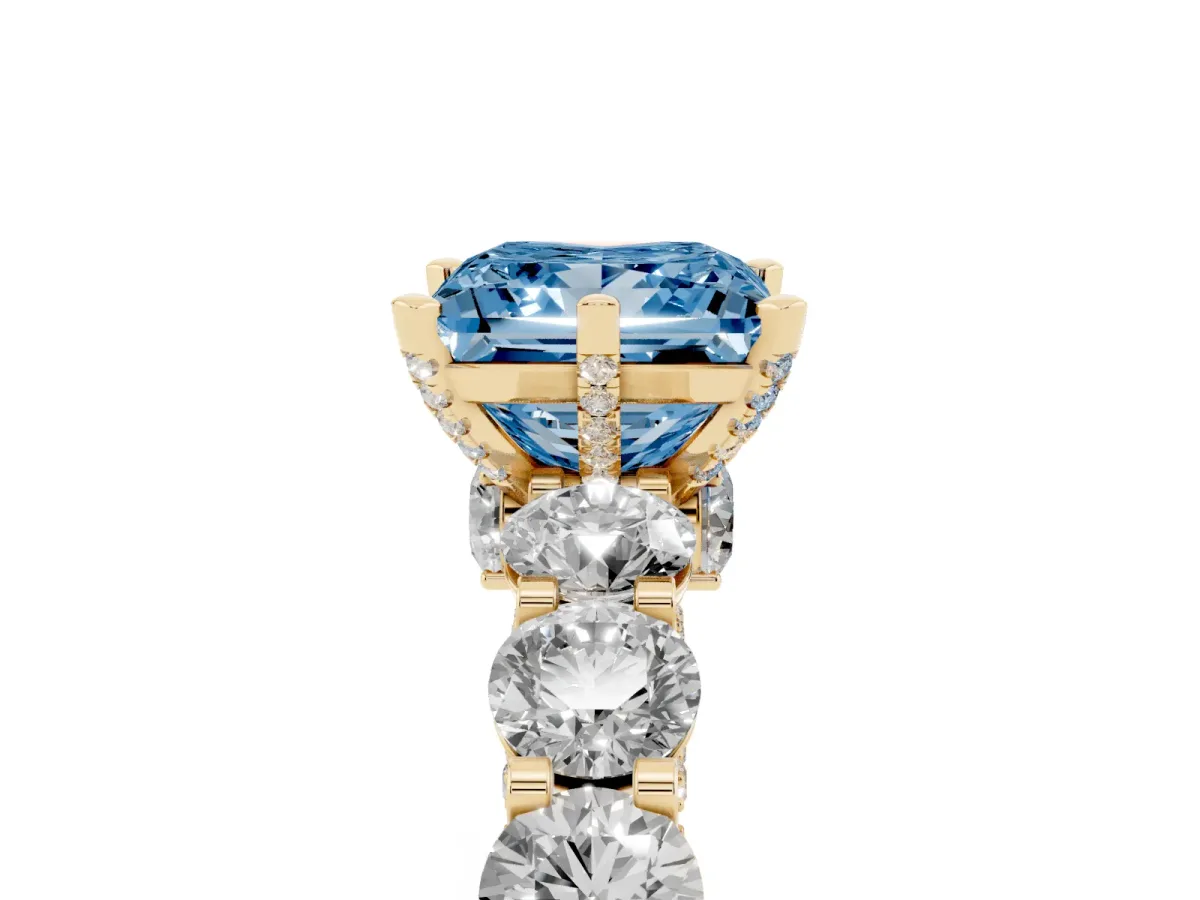 Fancy Blue Princess Cut Diamond Side Stone Engagement Ring with Four-Prong Setting Yellow gold