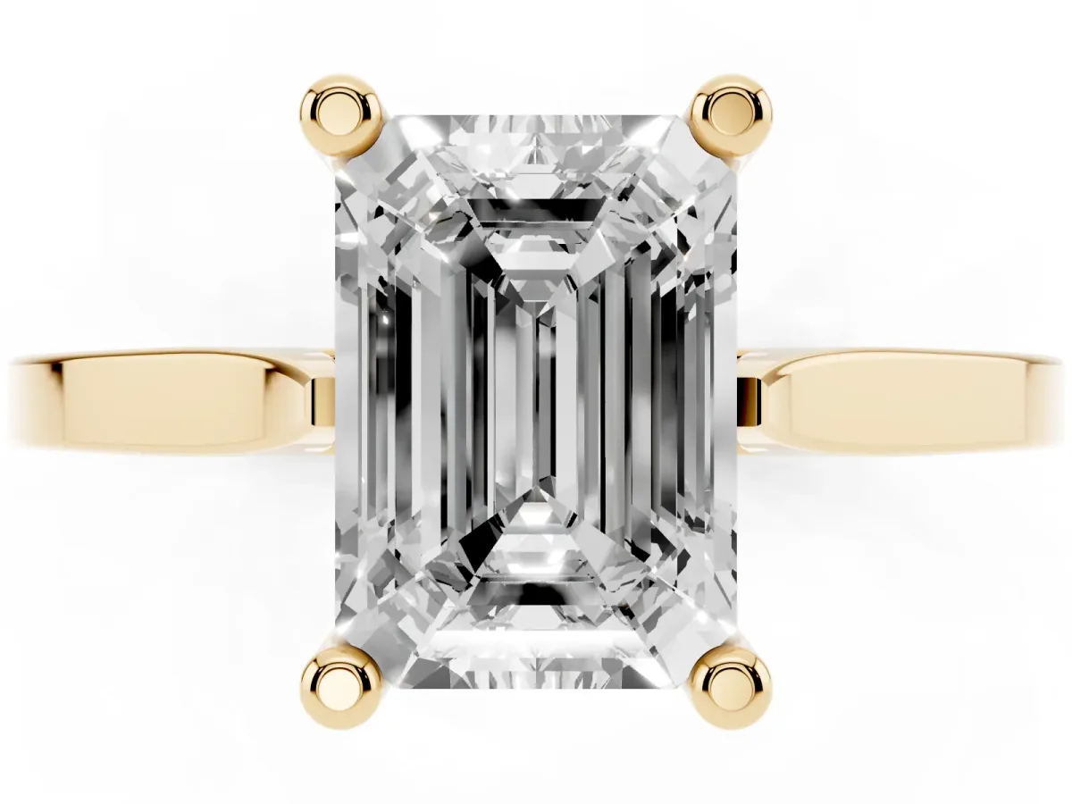 Emerald Cut Solitaire Diamond Ring with Four-Prong Setting and Tapered Band Yellow gold