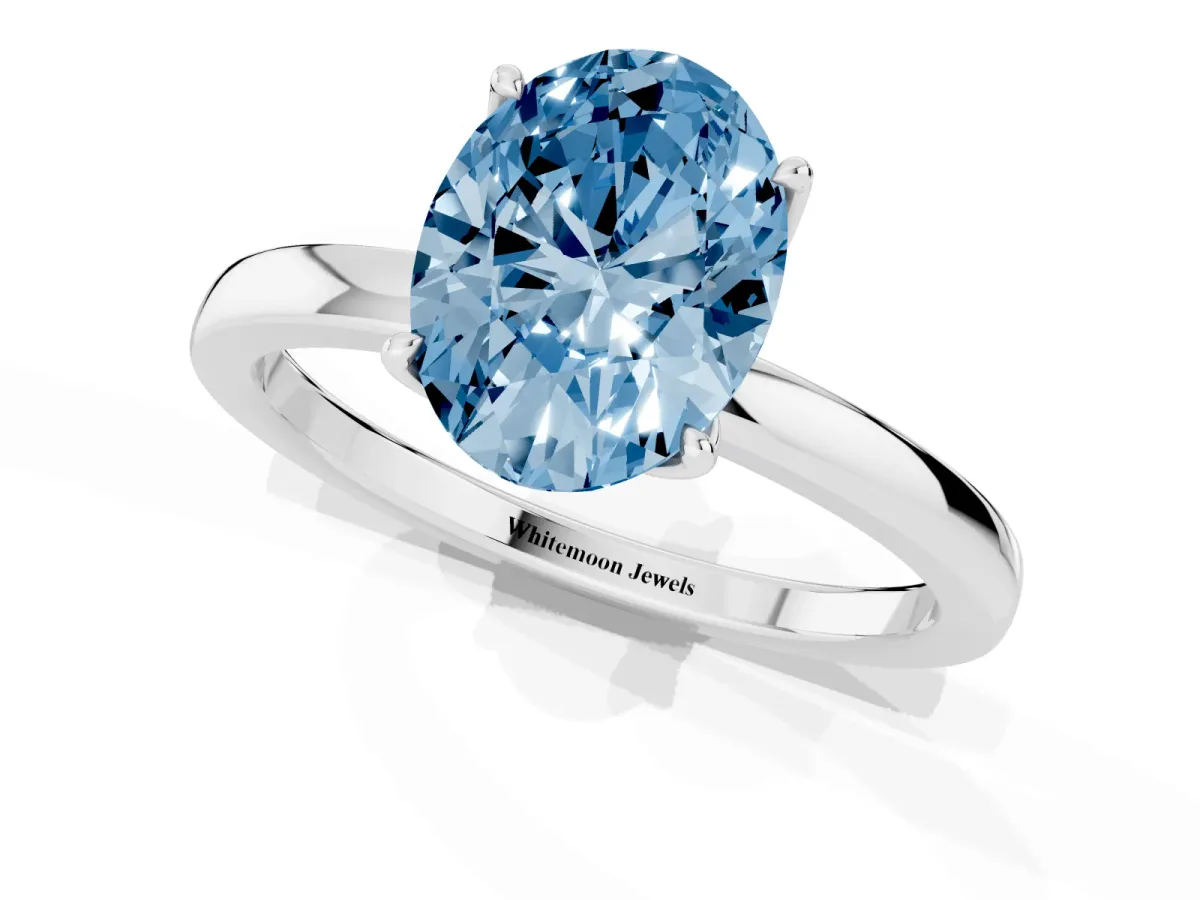 Fancy Blue Oval Cut Diamond Solitaire Ring with Thin Band and Prong Setting Silver