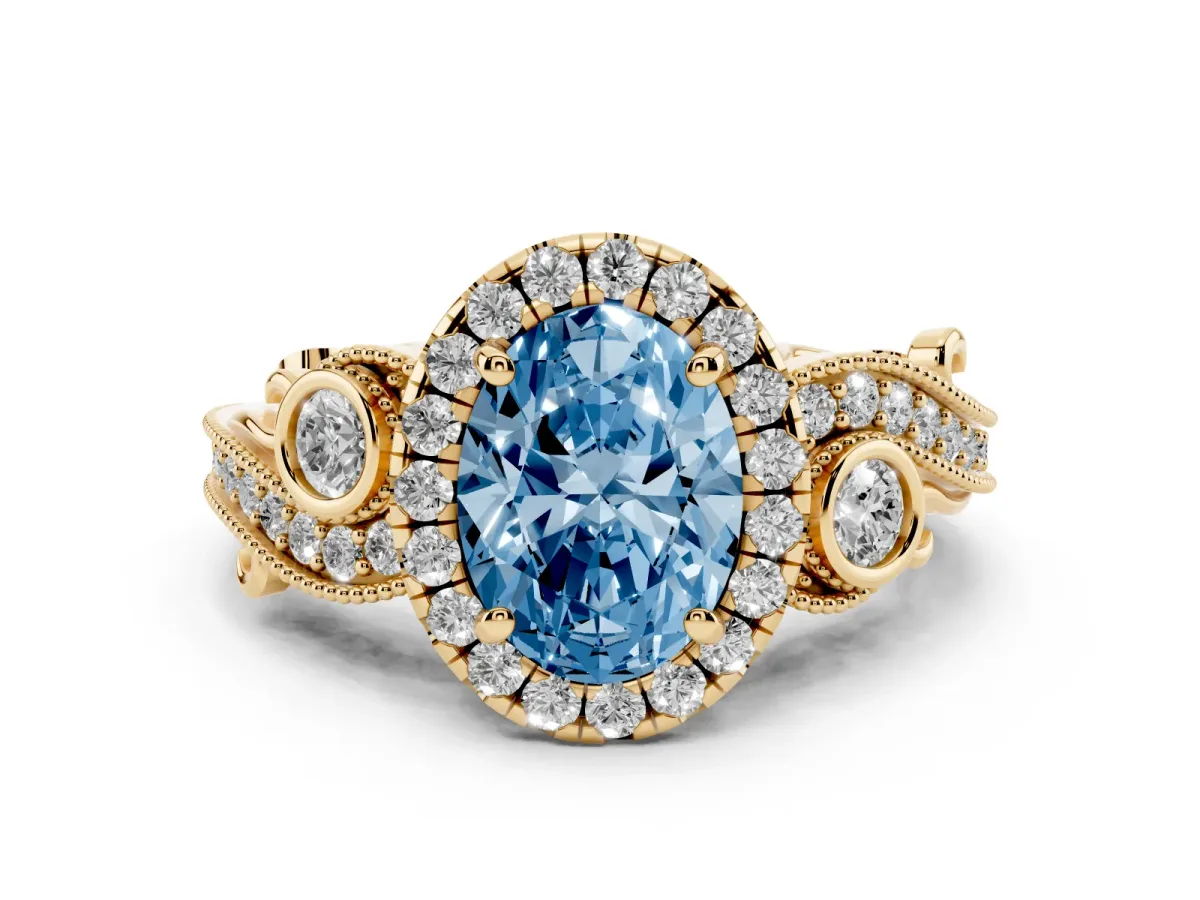 Fancy Blue Oval Cut Halo Diamond Ring with Milgrain and Bezel Accents on a Split Shank Band Yellow gold