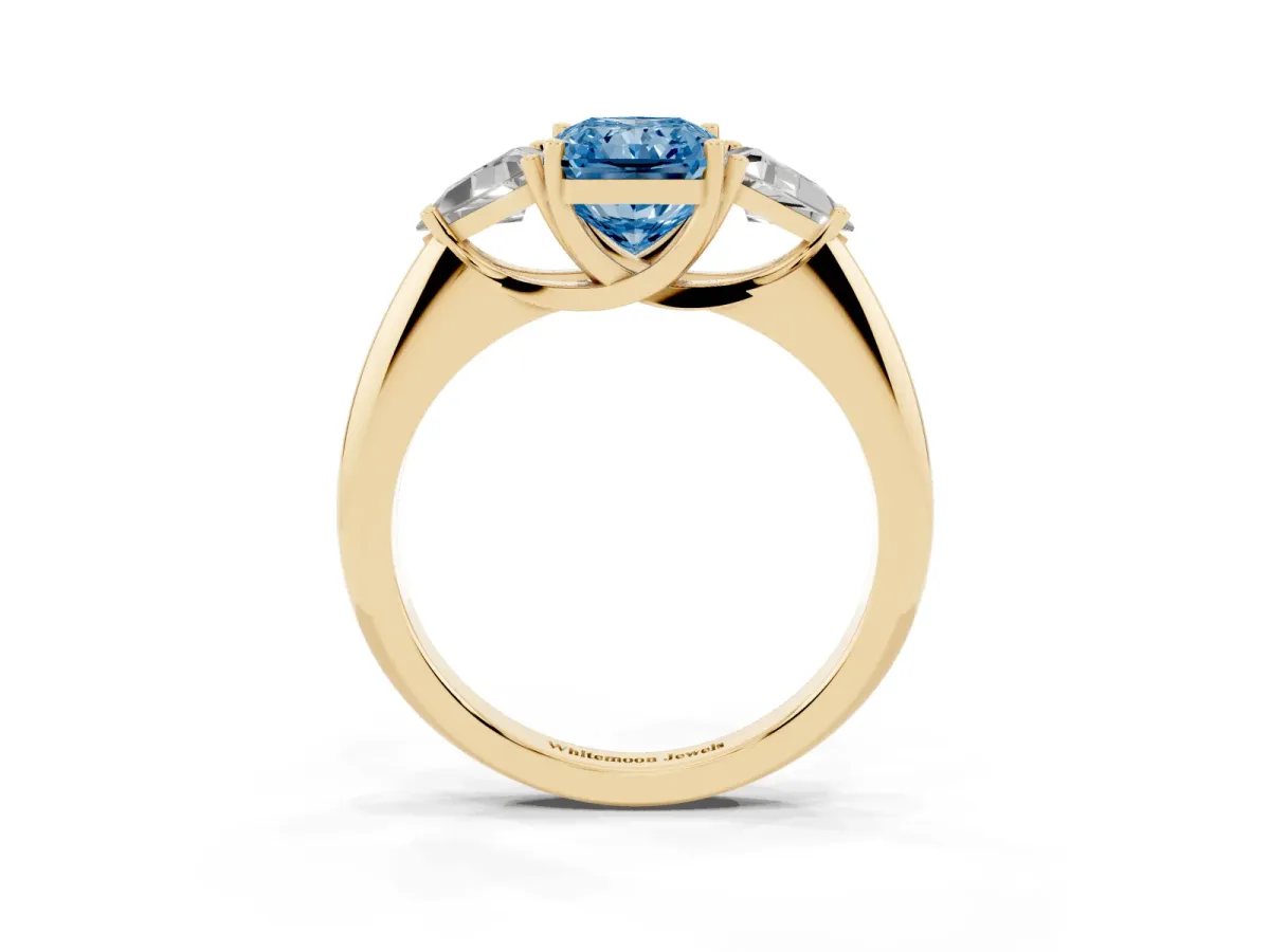 Fancy Blue Three-Stone Radiant Cut Diamond Engagement Ring with Trillion Side Stones and Prong Setting Yellow gold