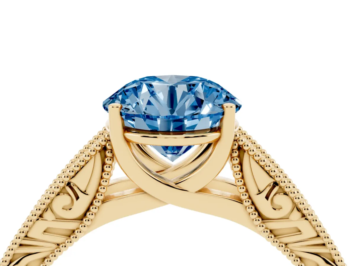 Fancy Blue Round Cut Diamond Solitaire Ring with Engraved Band and Four-Prong Setting Yellow gold