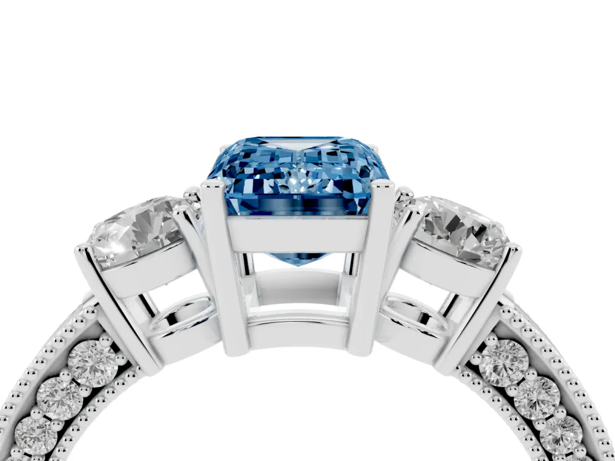 Fancy Blue Emerald Cut Three-Stone Diamond Ring with Pavé Band and Four-Prong Setting Silver