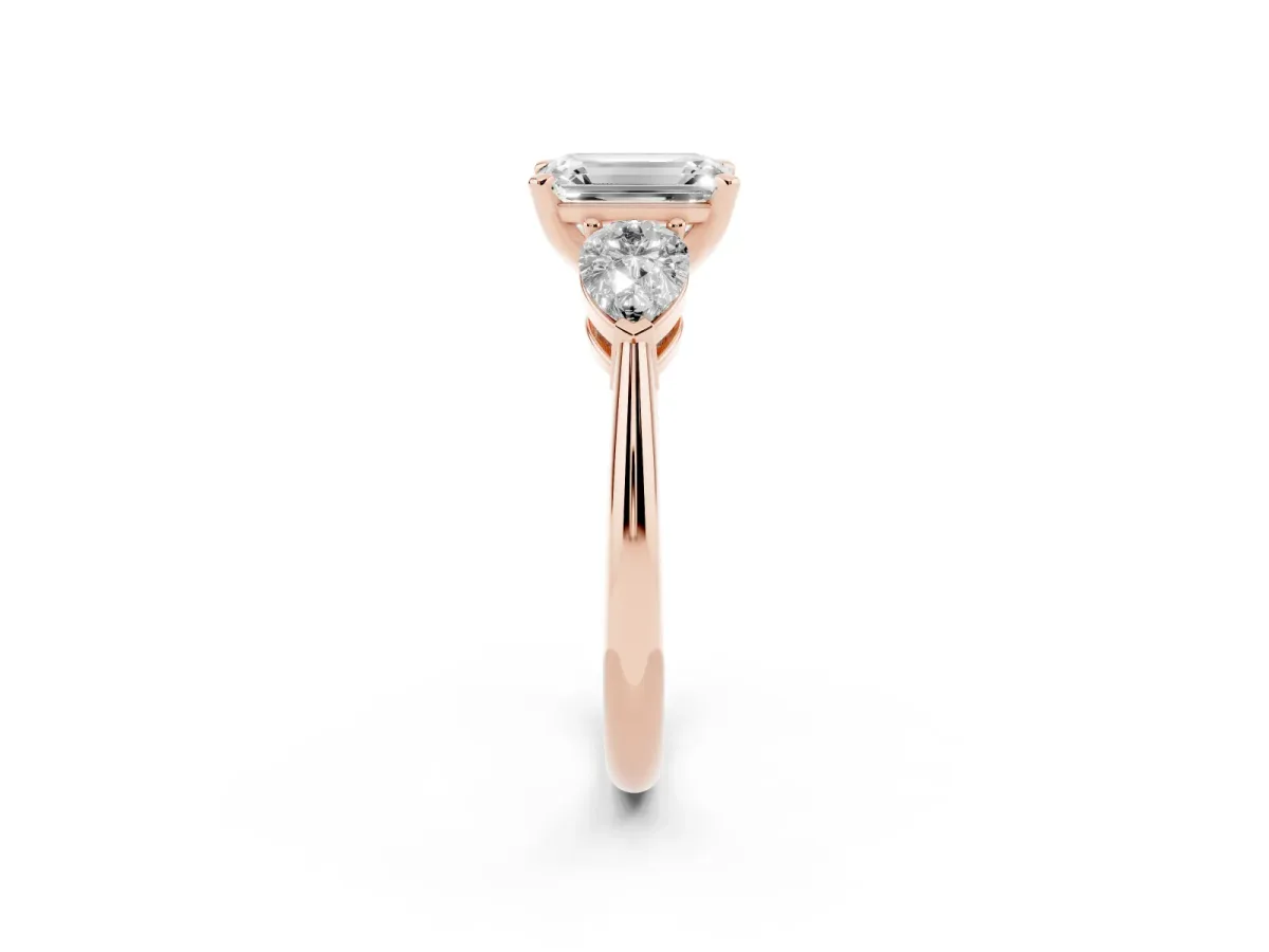 Three-Stone Emerald Cut Diamond Ring with Pear Side Stones and Four-Prong Setting Rose gold