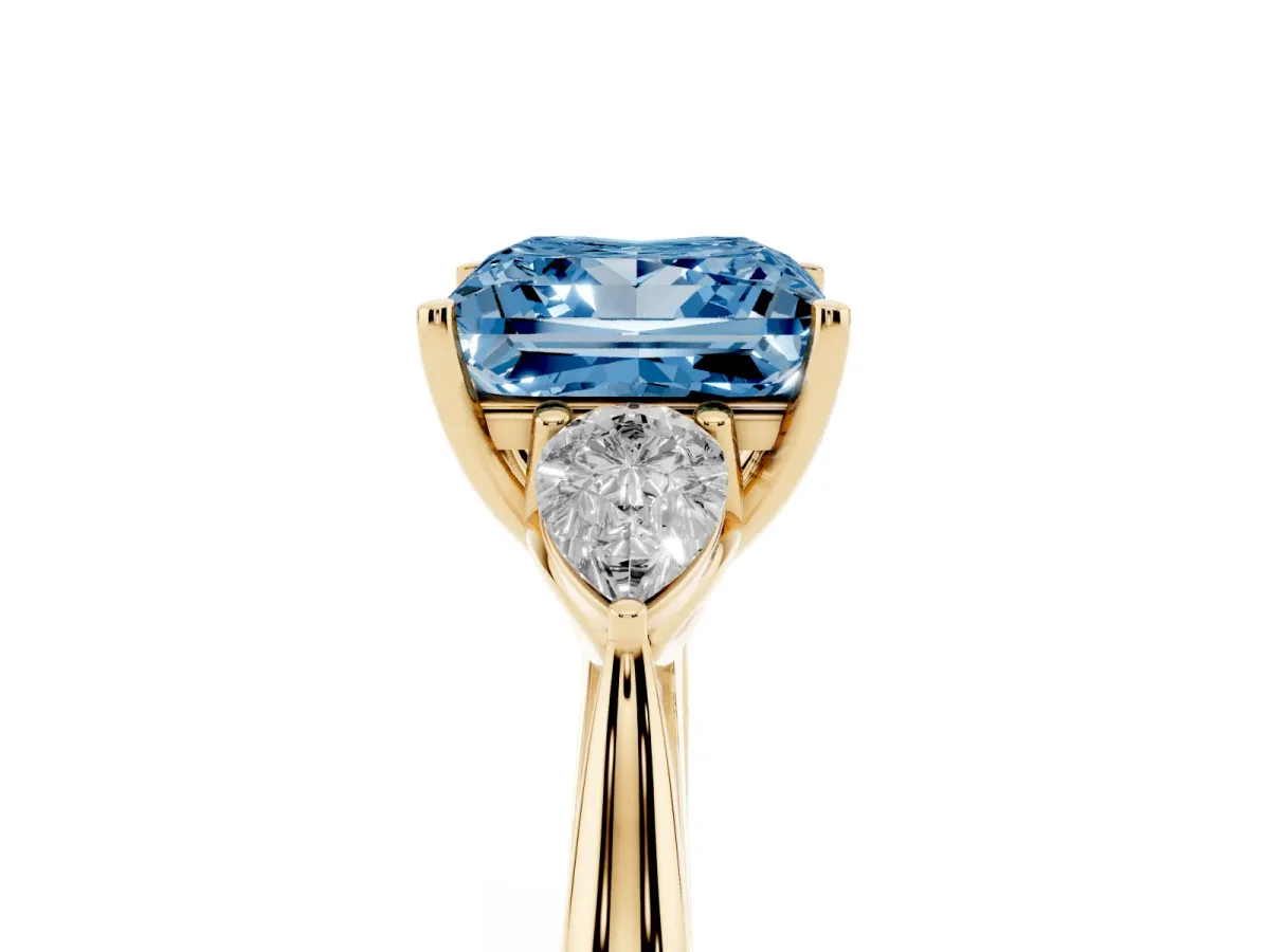 Fancy Blue Three-Stone Princess Cut Diamond Ring with Pear Side Stones in Four-Prong Setting Yellow gold