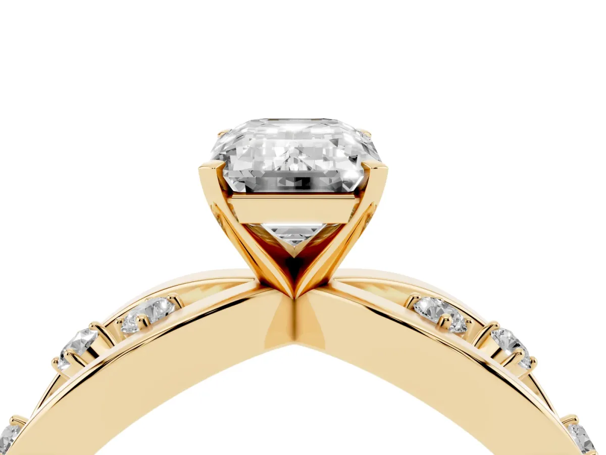 Emerald Cut Cut Solitaire Diamond with Side Stones on Criss-Cross Band and Four-Prong Setting Yellow gold