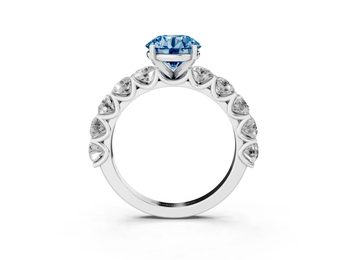 Fancy Blue Round Cut Diamond Prong Setting with Side Stones on a Pave Band Silver