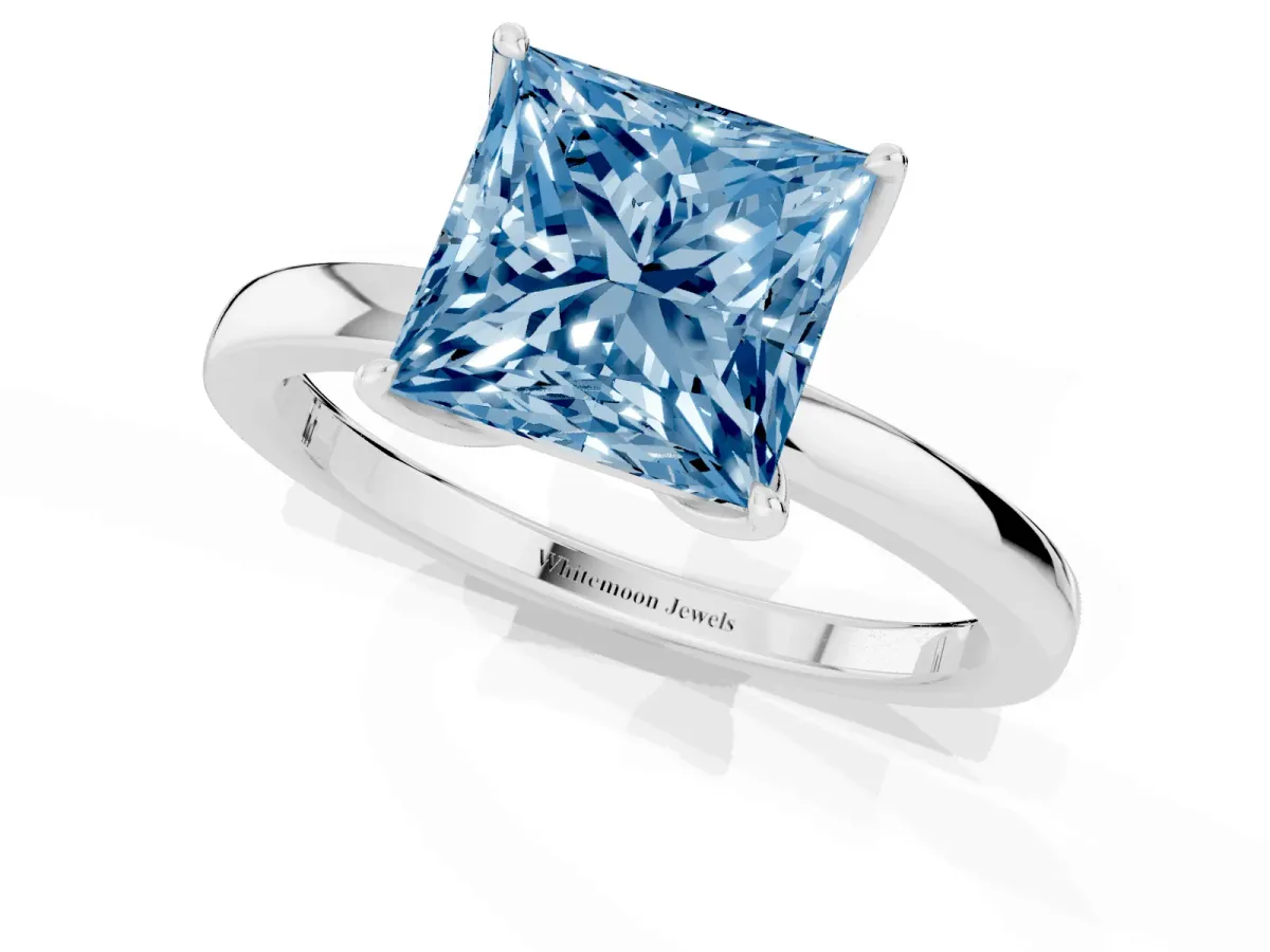Fancy Blue Princess Cut Diamond Solitaire Ring with Thin Band and Prong Setting Platinum