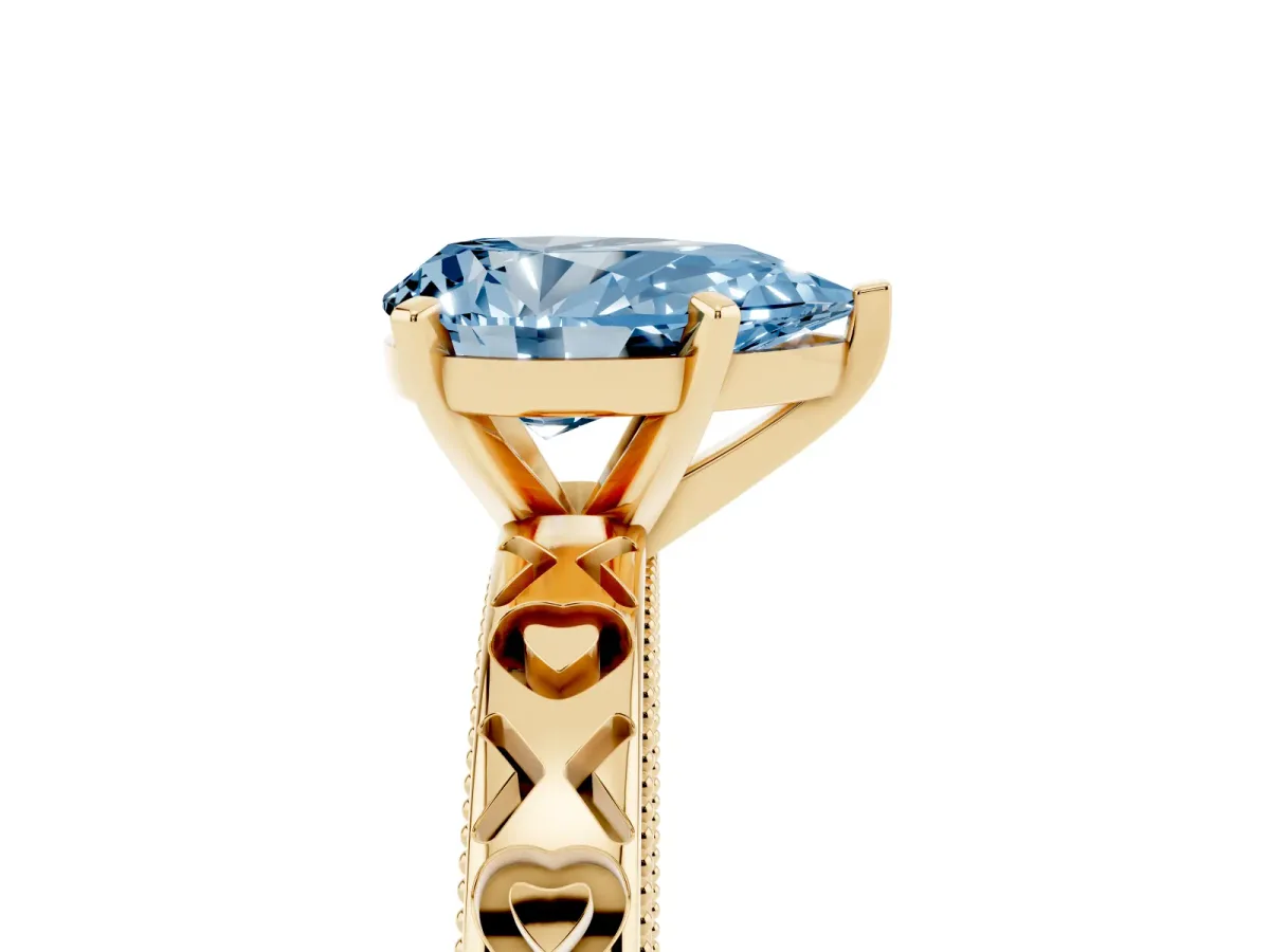 Fancy Blue Pear Cut Solitaire Diamond Engagement Ring with XO Engraved Band and Four-Prong Setting Yellow gold