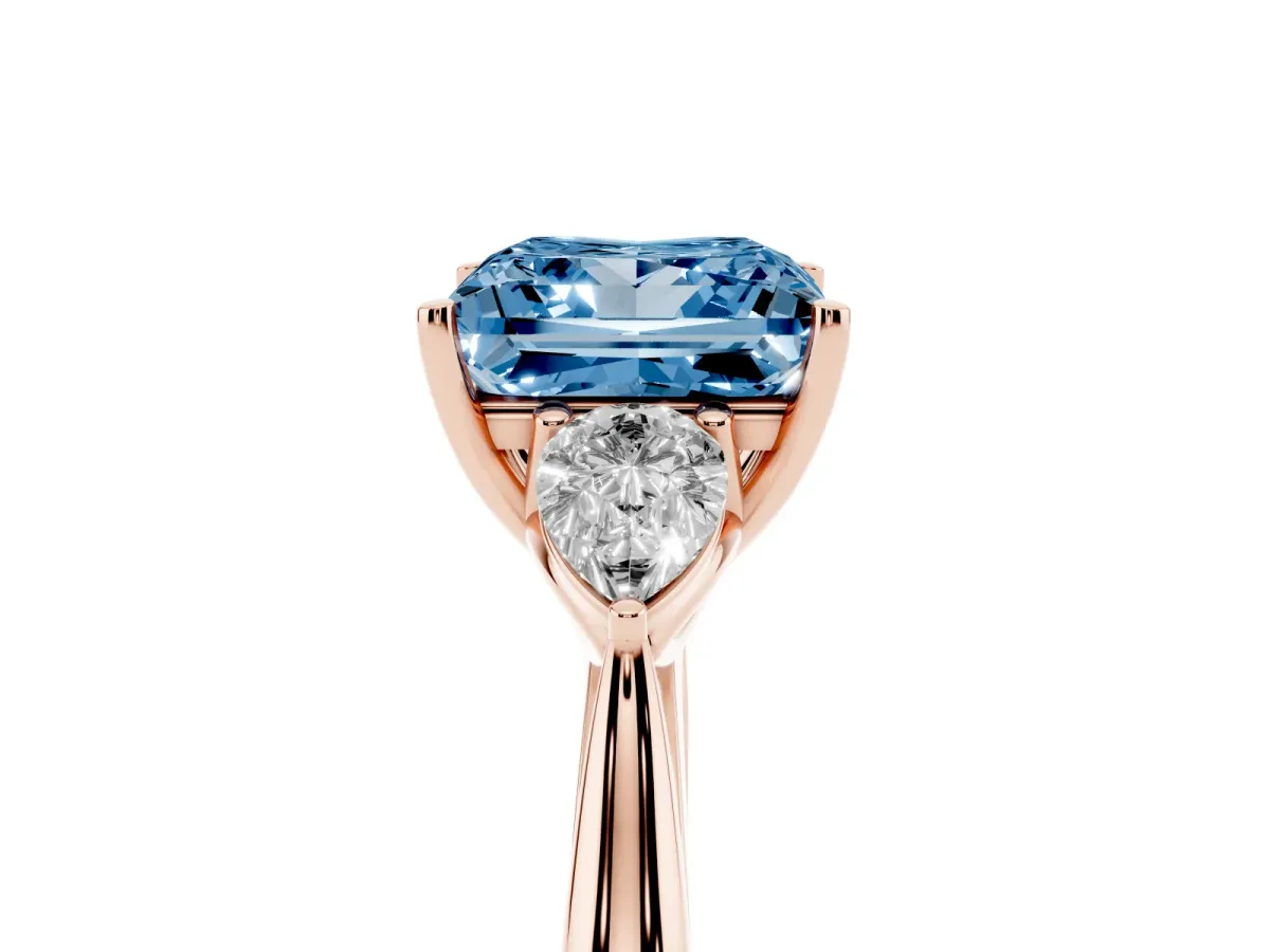 Fancy Blue Three-Stone Princess Cut Diamond Ring with Pear Side Stones in Four-Prong Setting Rose gold