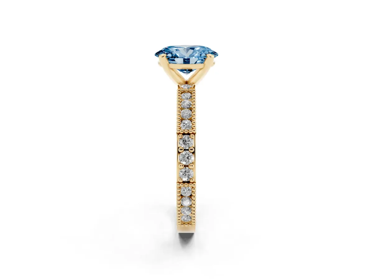 Fancy Blue Oval Cut Solitaire with Pavé Band and Four-Prong Setting Yellow gold