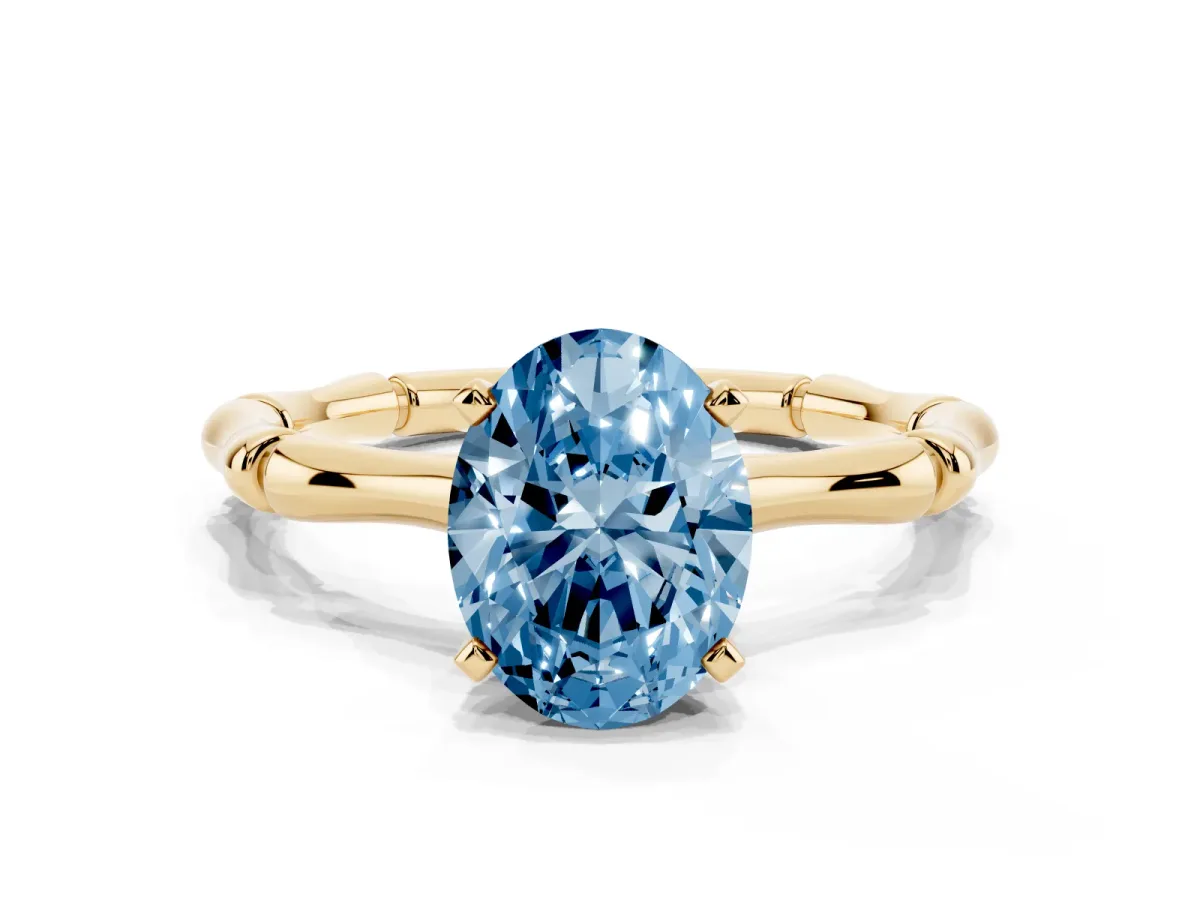 Fancy Blue Oval Cut Solitaire Diamond Ring with Bamboo Band and Four-Prong Setting Yellow gold