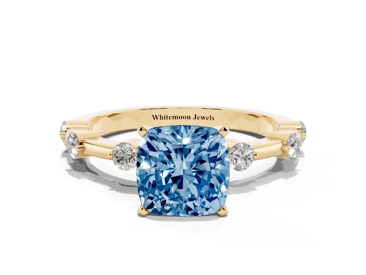 Fancy Blue Cushion Cut Solitaire Diamond Ring with Bezel Set Side Stones and Prong Setting Yellow gold