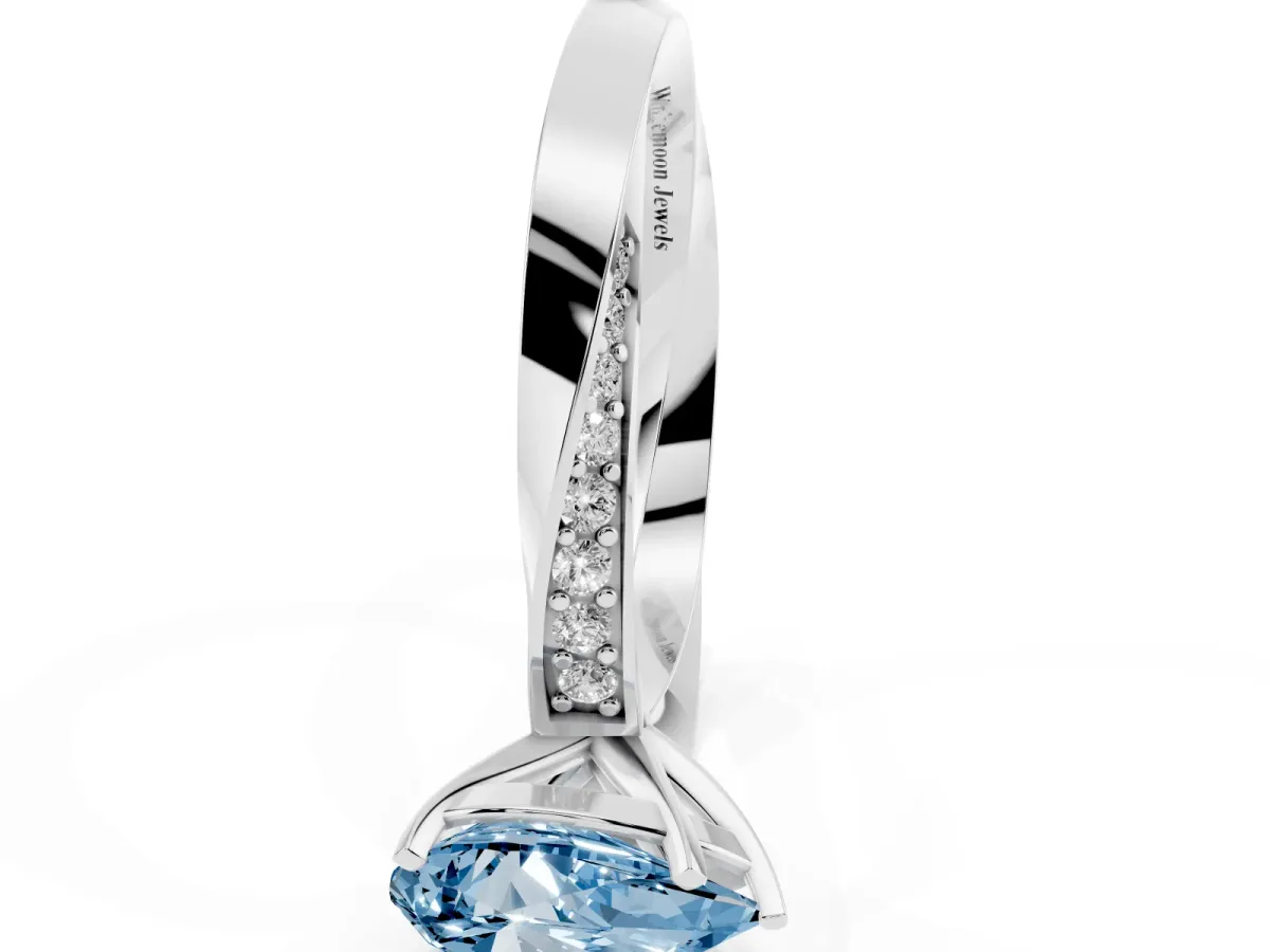 Fancy Blue Pear Cut Diamond Engagement Ring with Side Stone Accents and Four-Prong Setting Silver