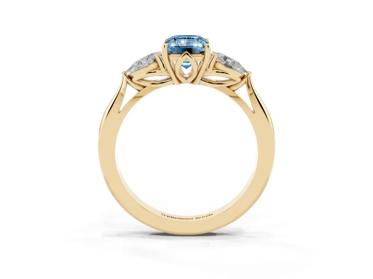 Fancy Blue Emerald Cut Diamond Three-Stone Ring with Pear Side Stones and Prong Setting Yellow gold